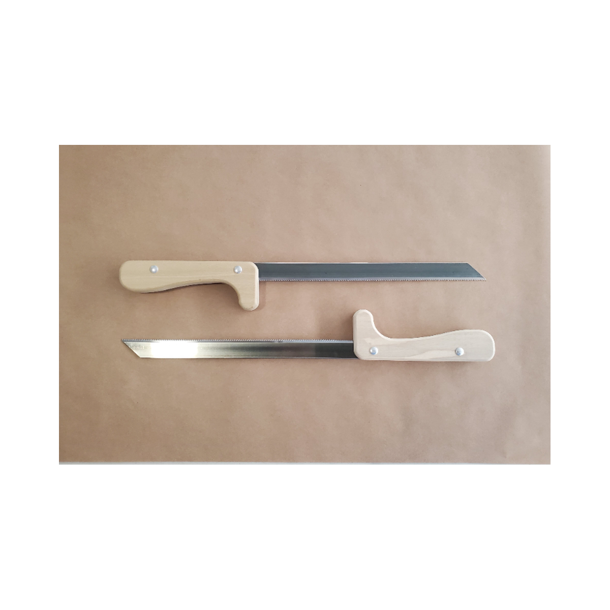 Two swords with beige handles on a brown paper background
